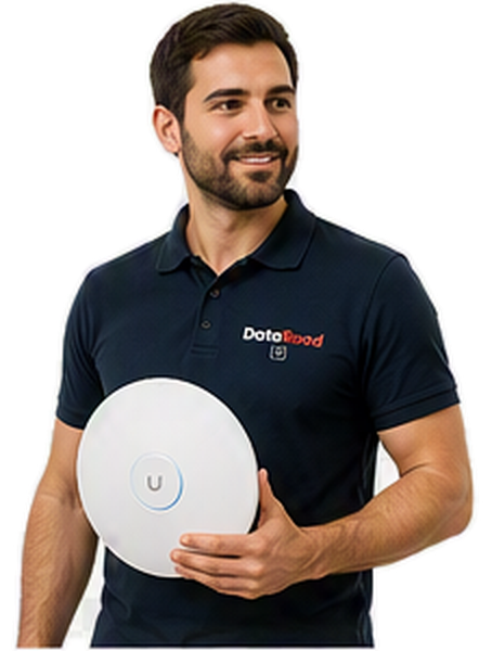 A bearded man in a navy polo shirt, holding a round white wireless device with a blue ring and a 'U' button, wearing a polo shirt with the DotaRoad logo.